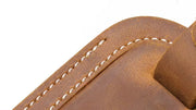 Handcrafted full grain leather luggage tag in brown, featuring white stitching and an adjustable strap with a brass buckle for secure attachment to luggage